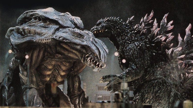 Godzilla fait face à Orga.  Cette image fait partie d'un article expliquant pourquoi Godzilla est rose dans la bande-annonce de New Empire.